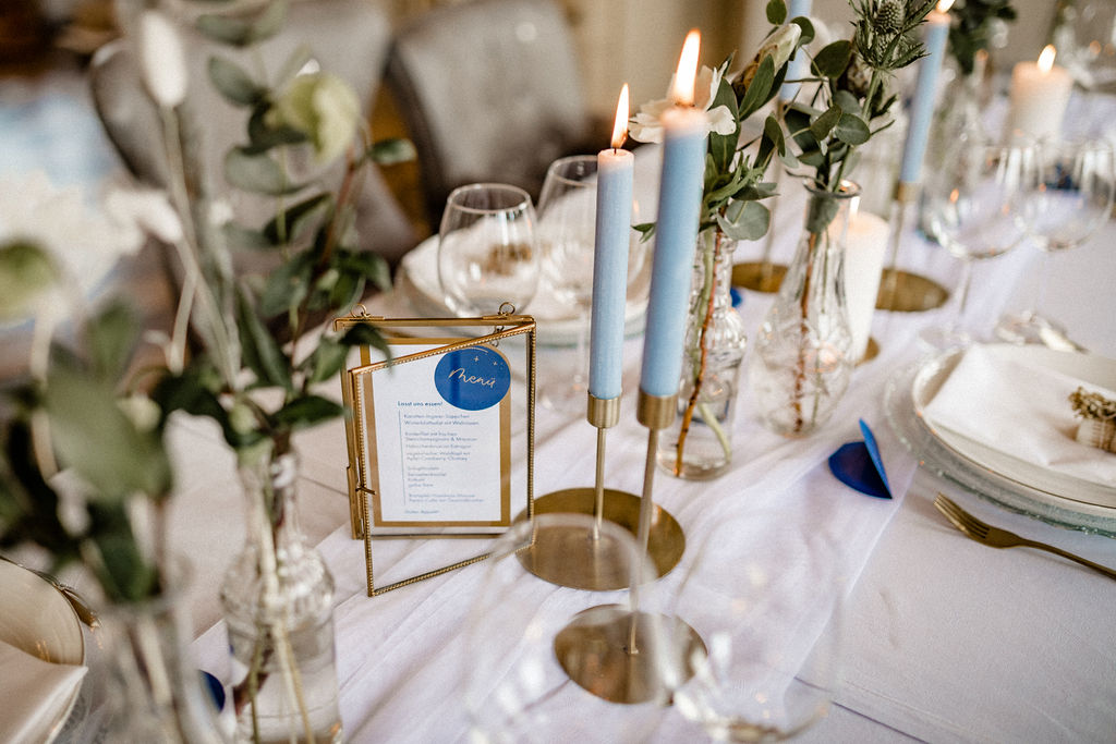 Tischdekoration mit blauen Kerzen und Eukalyptus beim Styled Shoot im Schloss Gamehl